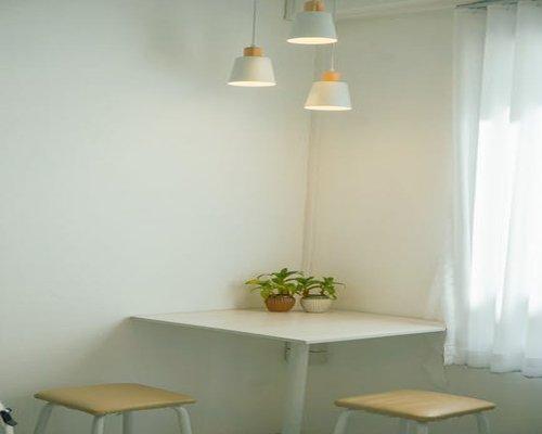 A neat and cozy living room corner with plants